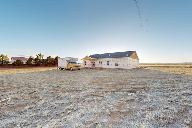 view of front of property with a rural view