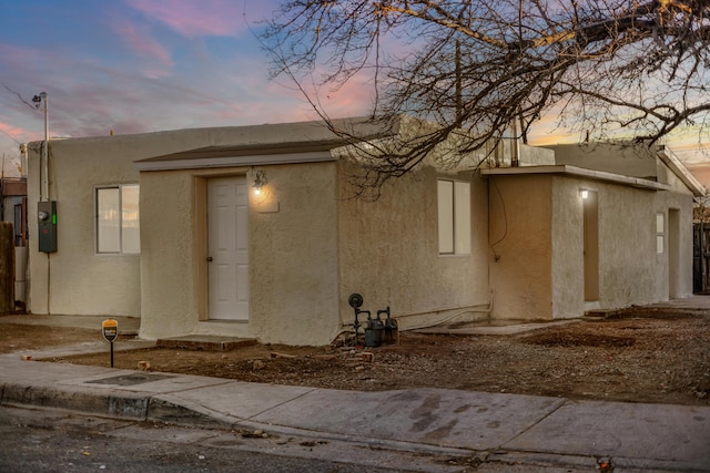 view of back house at dusk