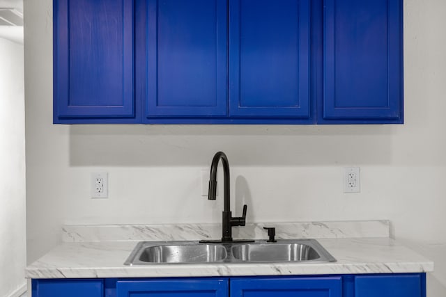 kitchen featuring blue cabinetry and sink