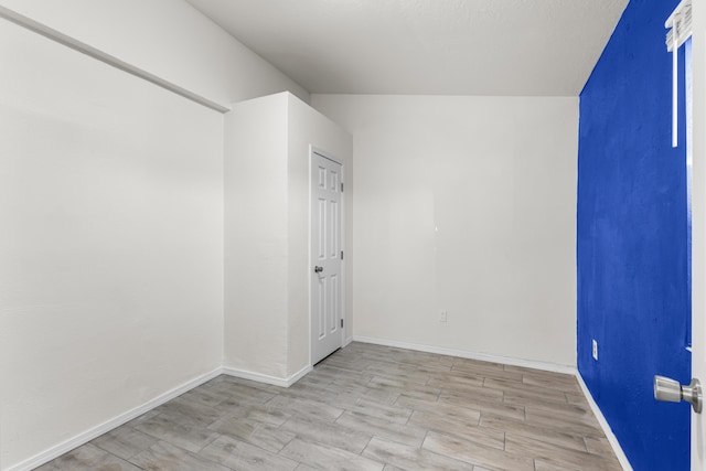 unfurnished room with light wood-type flooring