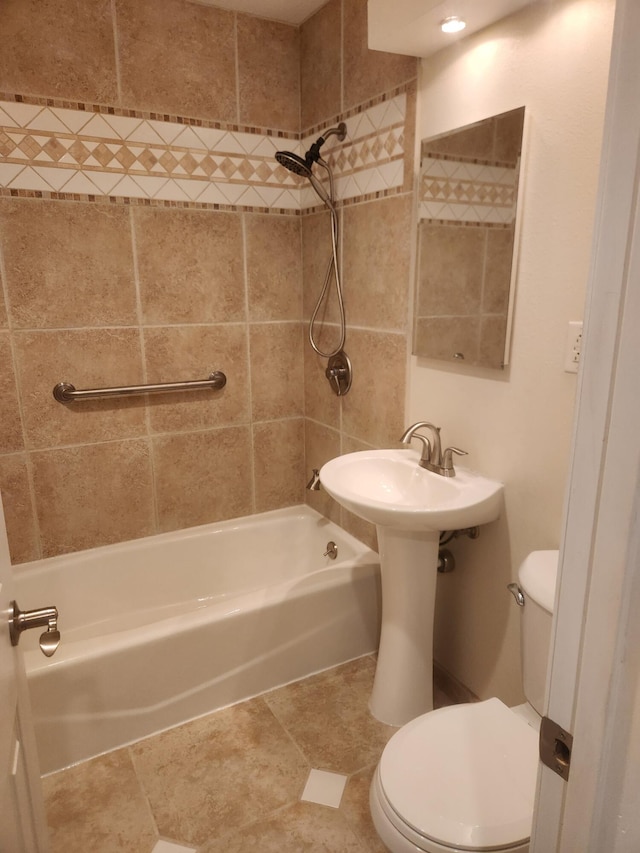 bathroom featuring tiled shower / bath and toilet