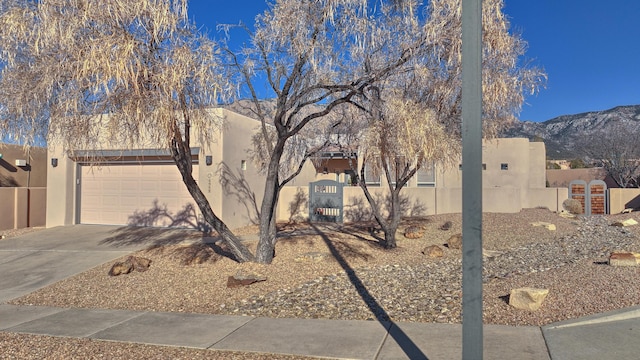 view of home's exterior featuring a garage and a mountain view