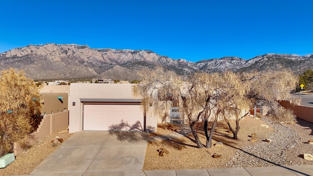 pueblo-style house with a mountain view and a garage