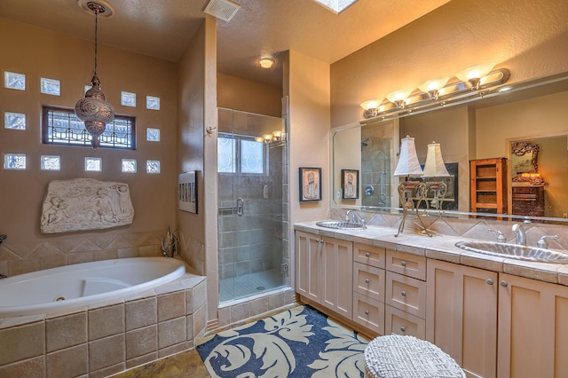 bathroom featuring vanity and independent shower and bath