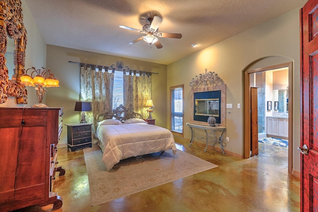 bedroom with ceiling fan and a textured ceiling