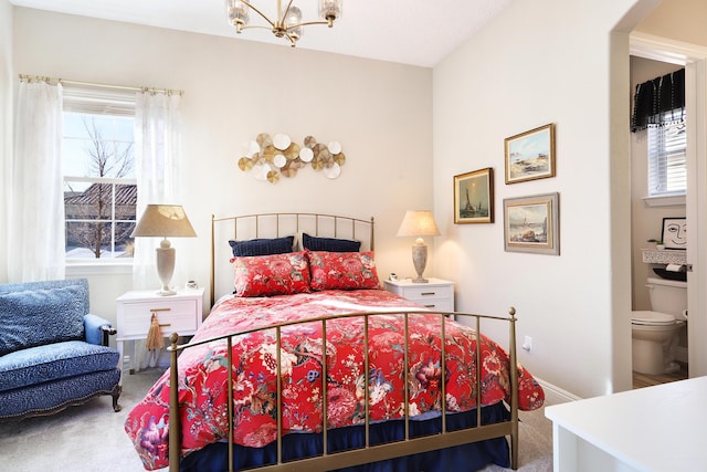 bedroom featuring carpet and a chandelier