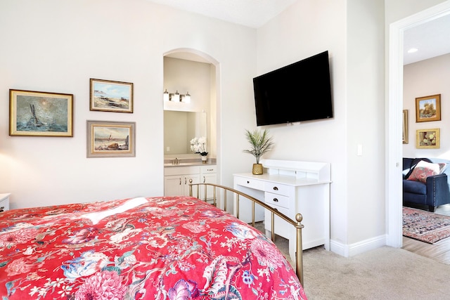 carpeted bedroom with ensuite bath