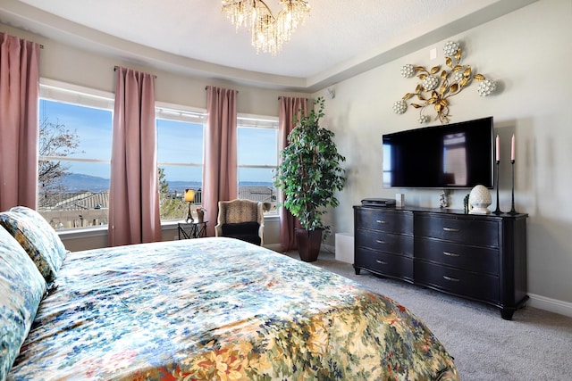 bedroom featuring light carpet and a notable chandelier