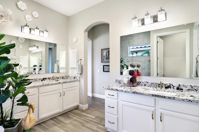 bathroom featuring vanity, wood-type flooring, and walk in shower