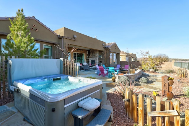 view of patio / terrace with a hot tub