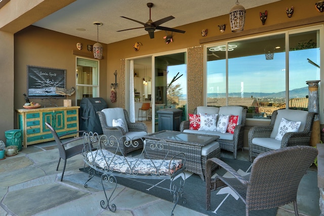 view of patio / terrace featuring a mountain view, outdoor lounge area, and ceiling fan