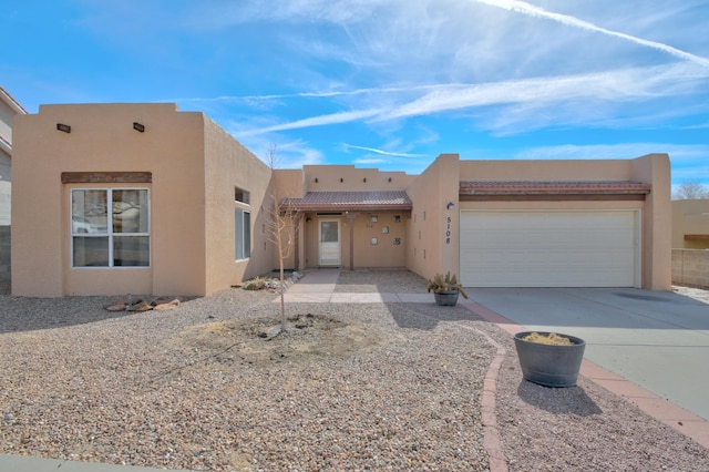 southwest-style home featuring a garage