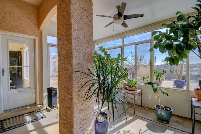 sunroom featuring ceiling fan