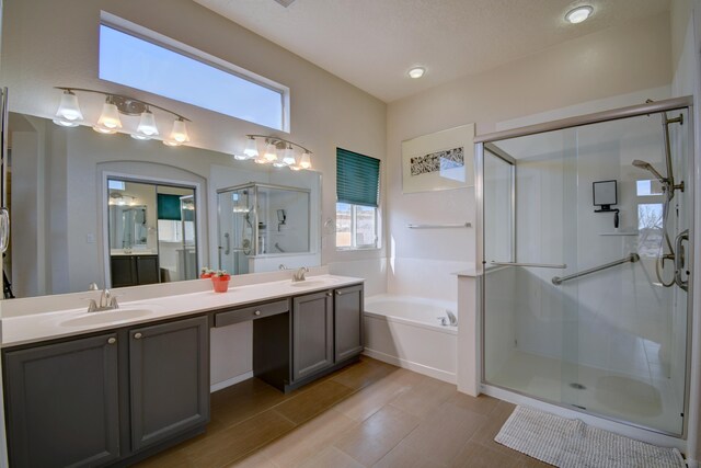 bathroom featuring vanity and shower with separate bathtub