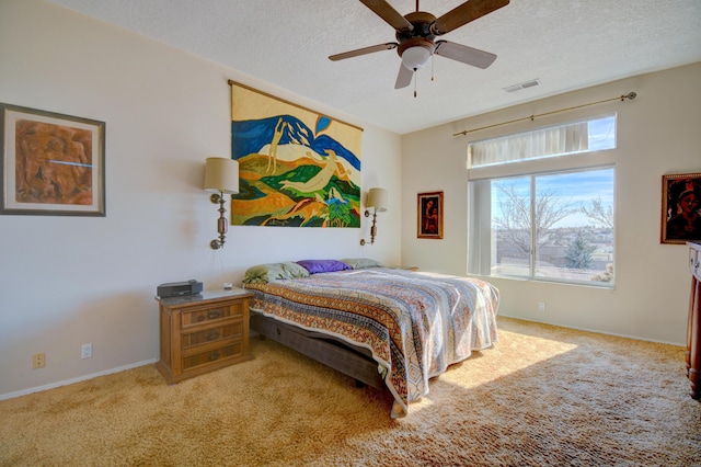 bedroom featuring ceiling fan, carpet flooring, and a textured ceiling