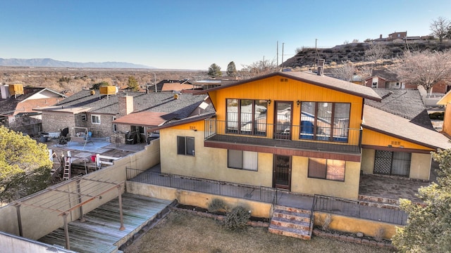 exterior space with a balcony and a mountain view