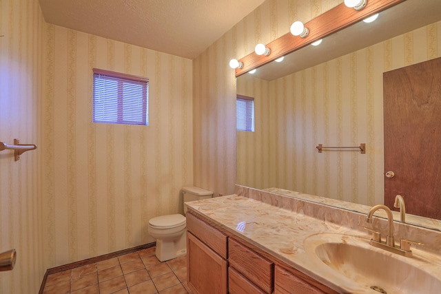 bathroom featuring tile patterned floors, toilet, a textured ceiling, and vanity