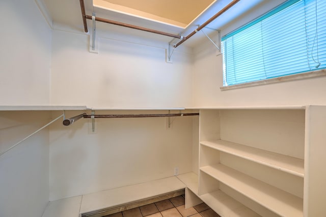 spacious closet with light tile patterned floors