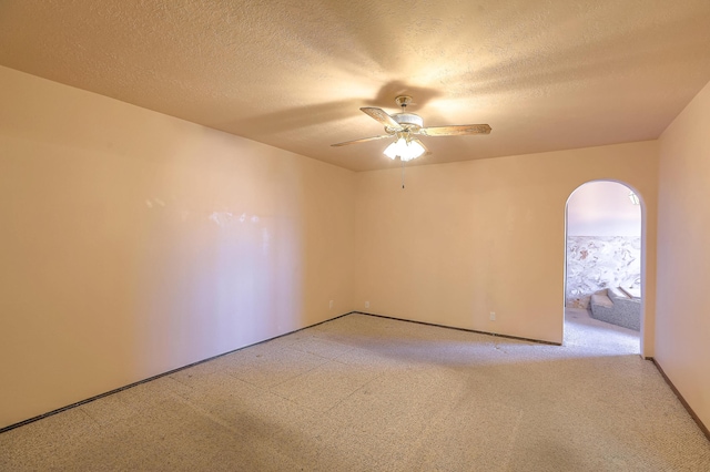 unfurnished room featuring light colored carpet, a textured ceiling, and ceiling fan