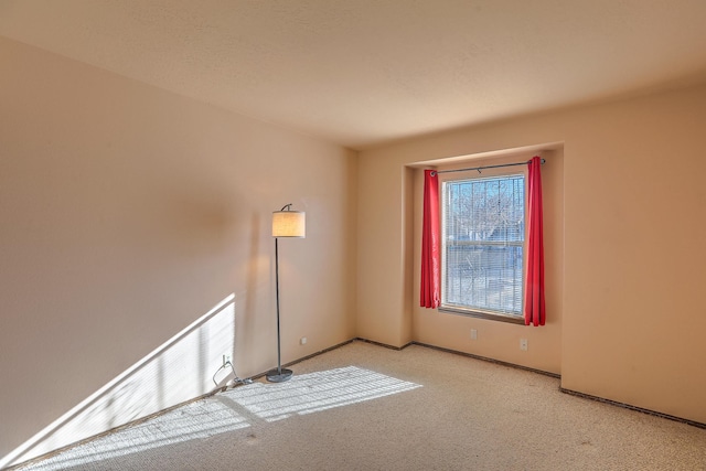 unfurnished room with light colored carpet