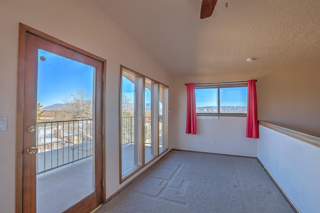 unfurnished sunroom featuring vaulted ceiling and a mountain view