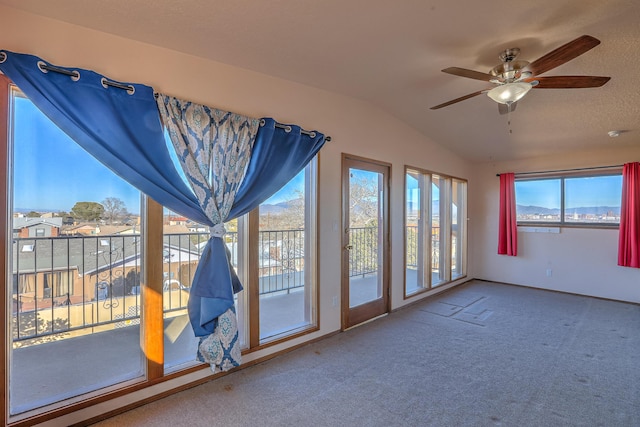 unfurnished sunroom with lofted ceiling and ceiling fan