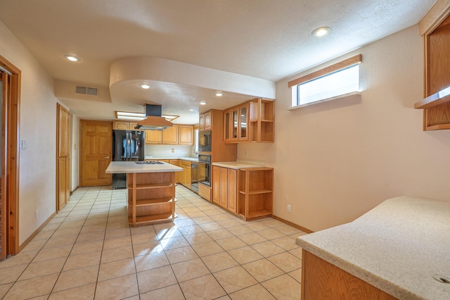 kitchen with light tile patterned floors, black appliances, a center island, and island exhaust hood