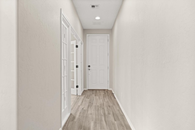 hallway with light wood-type flooring