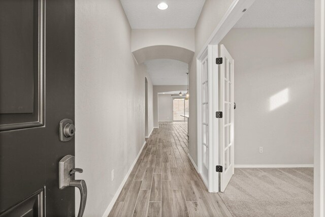 corridor with light hardwood / wood-style flooring