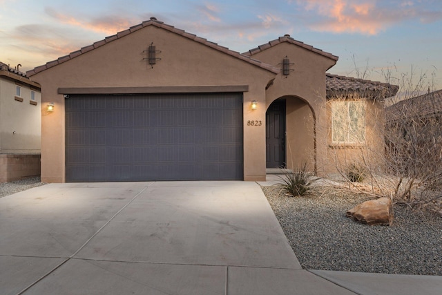 mediterranean / spanish-style house featuring a garage