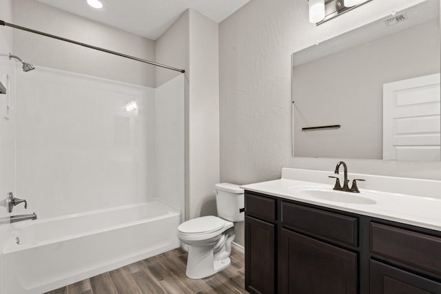 full bathroom with vanity, toilet, hardwood / wood-style floors, and shower / bathing tub combination