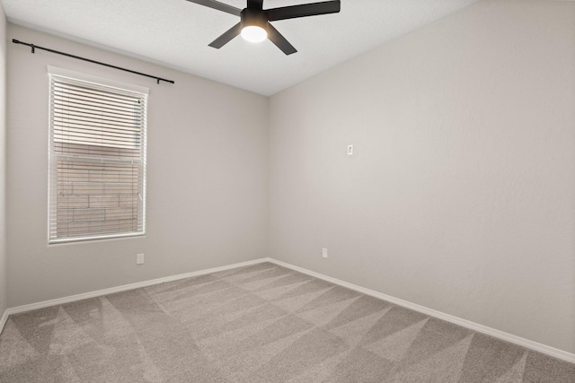 carpeted empty room featuring ceiling fan