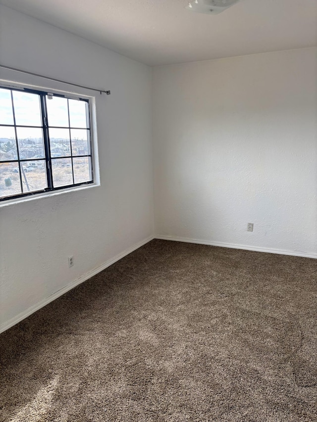 empty room with carpet flooring and baseboards