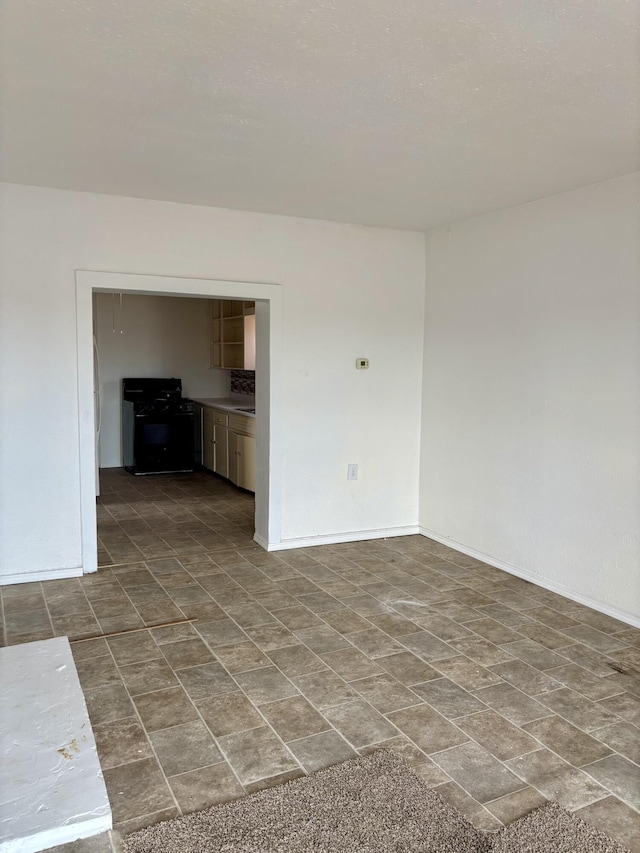 unfurnished room with baseboards