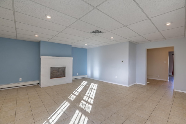 unfurnished living room with a baseboard radiator, a paneled ceiling, a baseboard heating unit, visible vents, and a brick fireplace