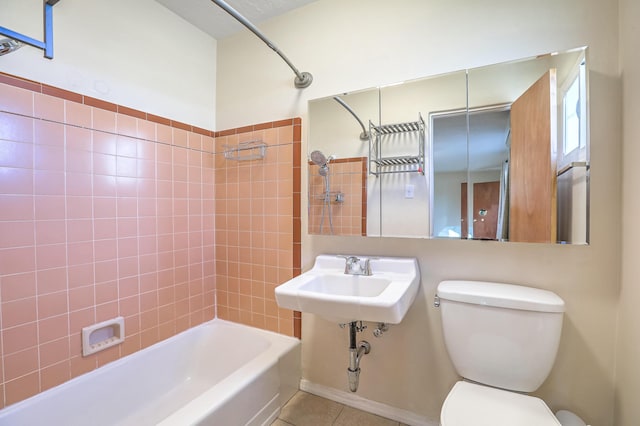 bathroom with a sink, shower / tub combination, toilet, and tile patterned floors