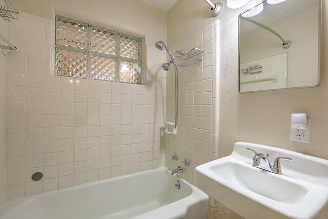 bathroom featuring a sink and bathing tub / shower combination