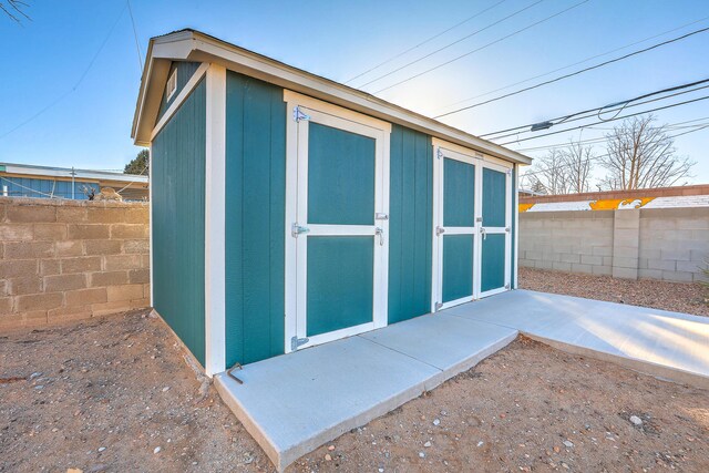 view of shed with a fenced backyard