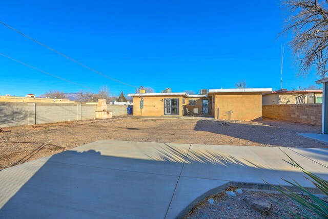 back of house with a patio area, fence, and stucco siding