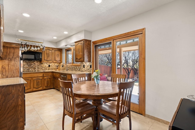 dining room featuring light tile patterned flooring, recessed lighting, a textured ceiling, and baseboards