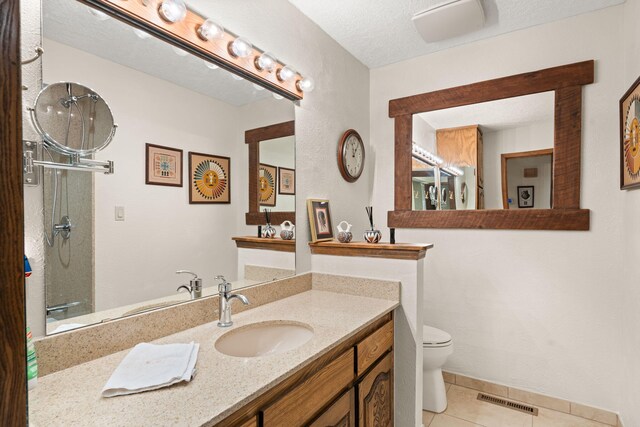 full bathroom featuring tile patterned floors, visible vents, toilet, a shower, and vanity