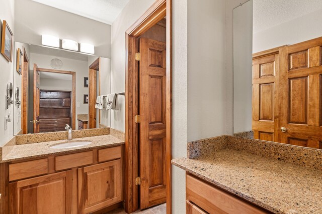 bathroom featuring a textured ceiling and vanity