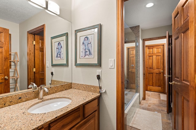 bathroom with vanity and a textured ceiling