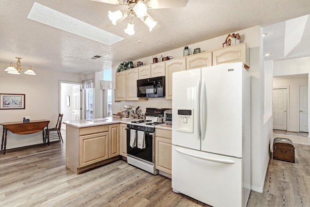 kitchen with white appliances, light hardwood / wood-style floors, kitchen peninsula, and a textured ceiling