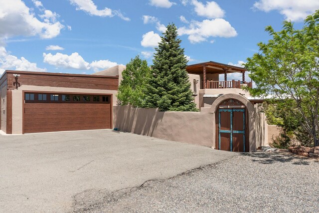 22 Del Charro Rd, Lamy, NM 87540 - view of front of property with a garage and a balcony