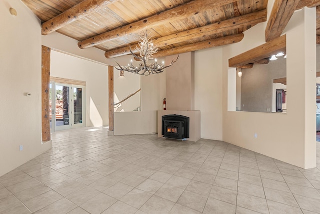 22 Del Charro Rd, Lamy, NM 87540 - unfurnished living room featuring beamed ceiling, wooden ceiling, a chandelier, and light tile patterned flooring