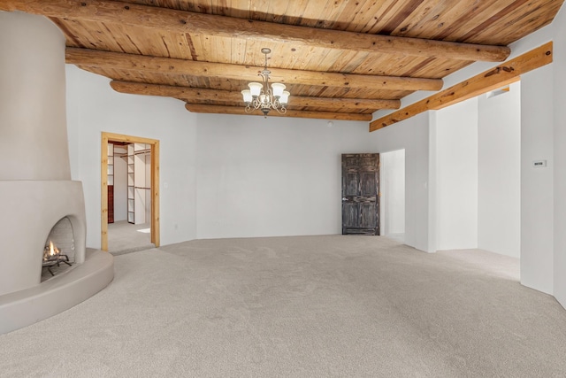 22 Del Charro Rd, Lamy, NM 87540 - unfurnished living room with wood ceiling, a chandelier, beamed ceiling, and carpet flooring