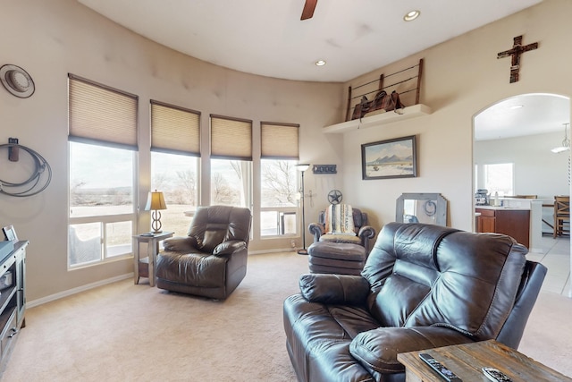 carpeted living room with a wealth of natural light and ceiling fan