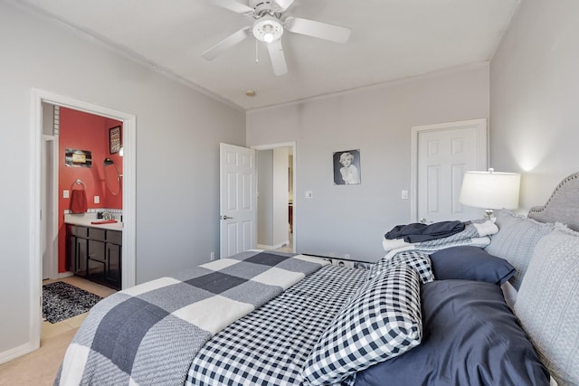 carpeted bedroom with ensuite bathroom, sink, and ceiling fan