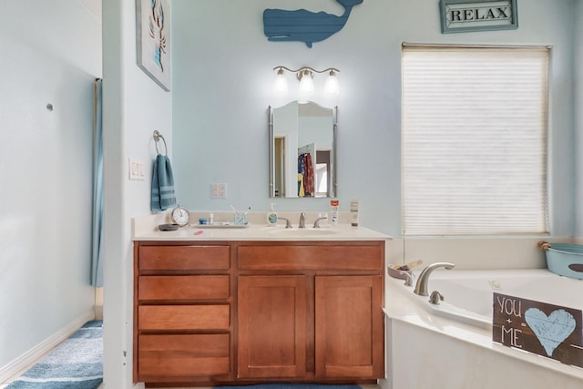 bathroom featuring vanity and a tub